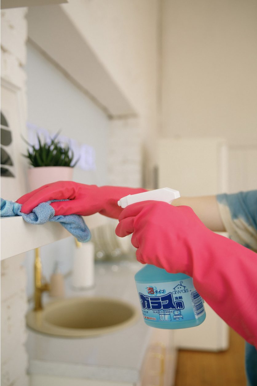 Wiping down a kitchen shelf